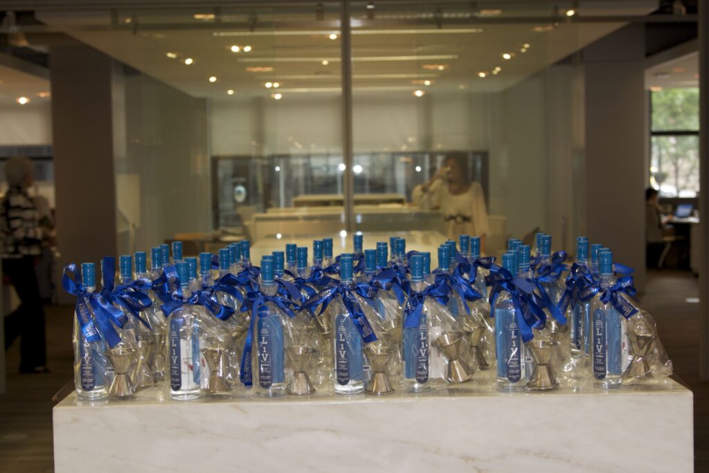 Branded LiV vodka gift bottles tied with SL Green ribbons at a curated corporate activation in NYC